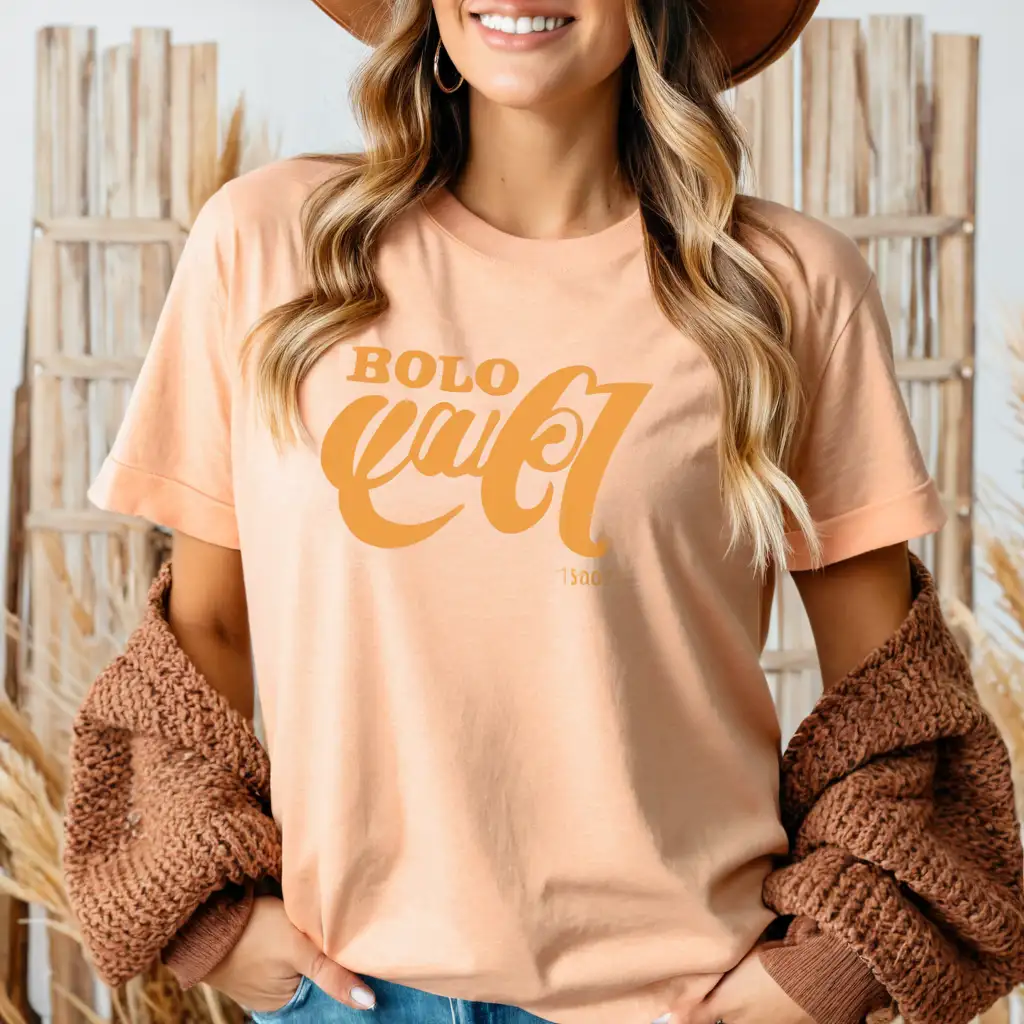 younger woman wearing light heather peach bella canvas 3001 t-shirt mockup, with knitted brown cardigan , cowboy hat boho background