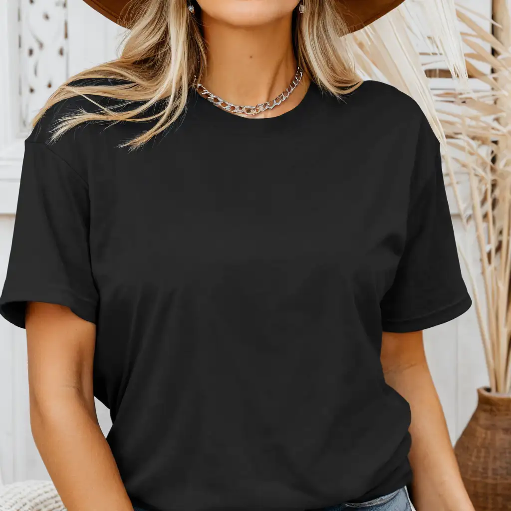 blonde woman wearing bella canvas 3001 black t-shirt mockup, with cowgirl hat and silver necklace, boho home background