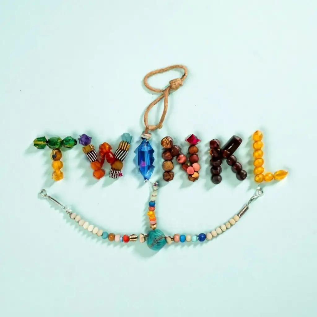 logo, beads, with the text "Twinkl Trinkets", typography