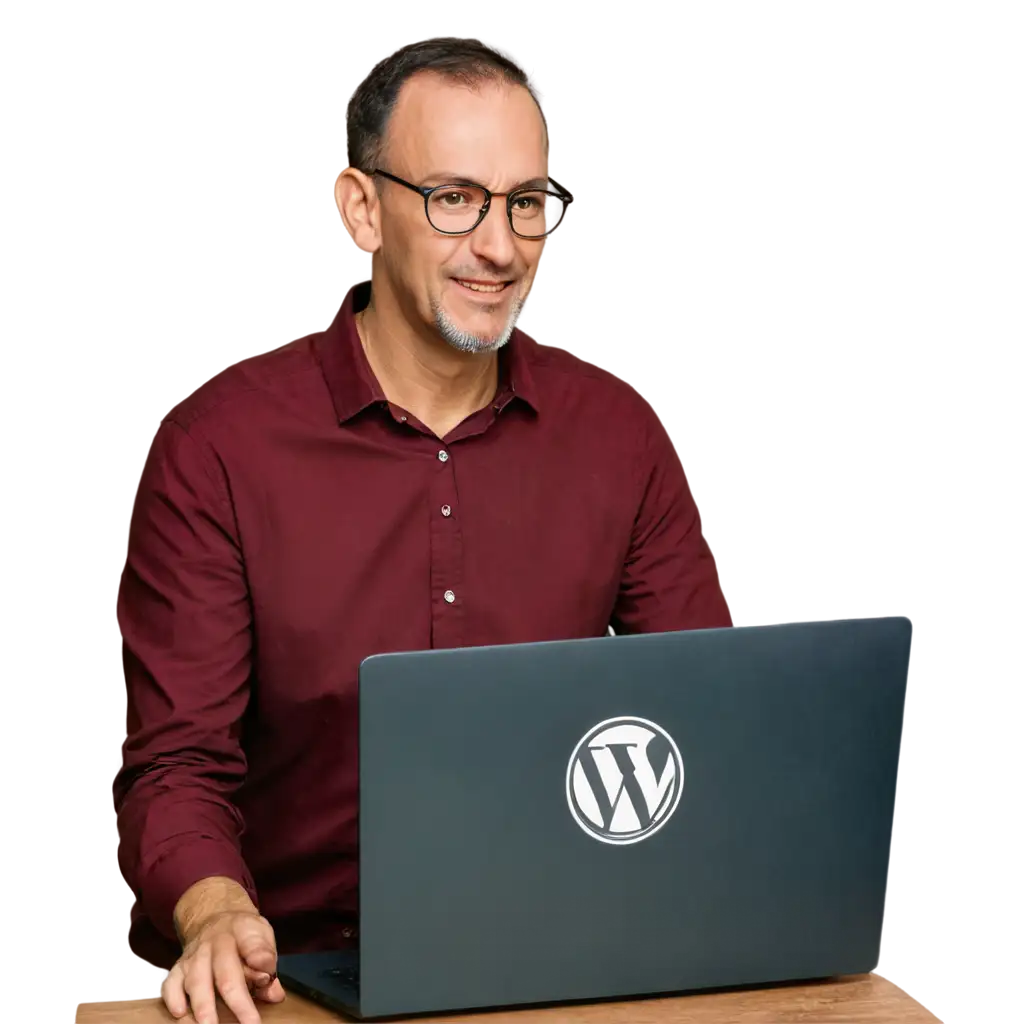 программист на рабочем месте. На стаоле перед ним ноутбук, на экране которого логотип Wordpress. Вид сбоку, так, что виден экран ноутбука с логотипом Wordpress. Программисту 50 лет и он в очках
