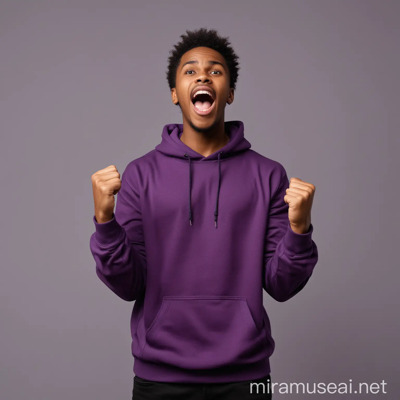Excited African black young man , shouting overjoyed as he wins a lottery , putting on a dark purple sweatshirt and black pants , raise his clenched fist up , standing against gray space , facing camera