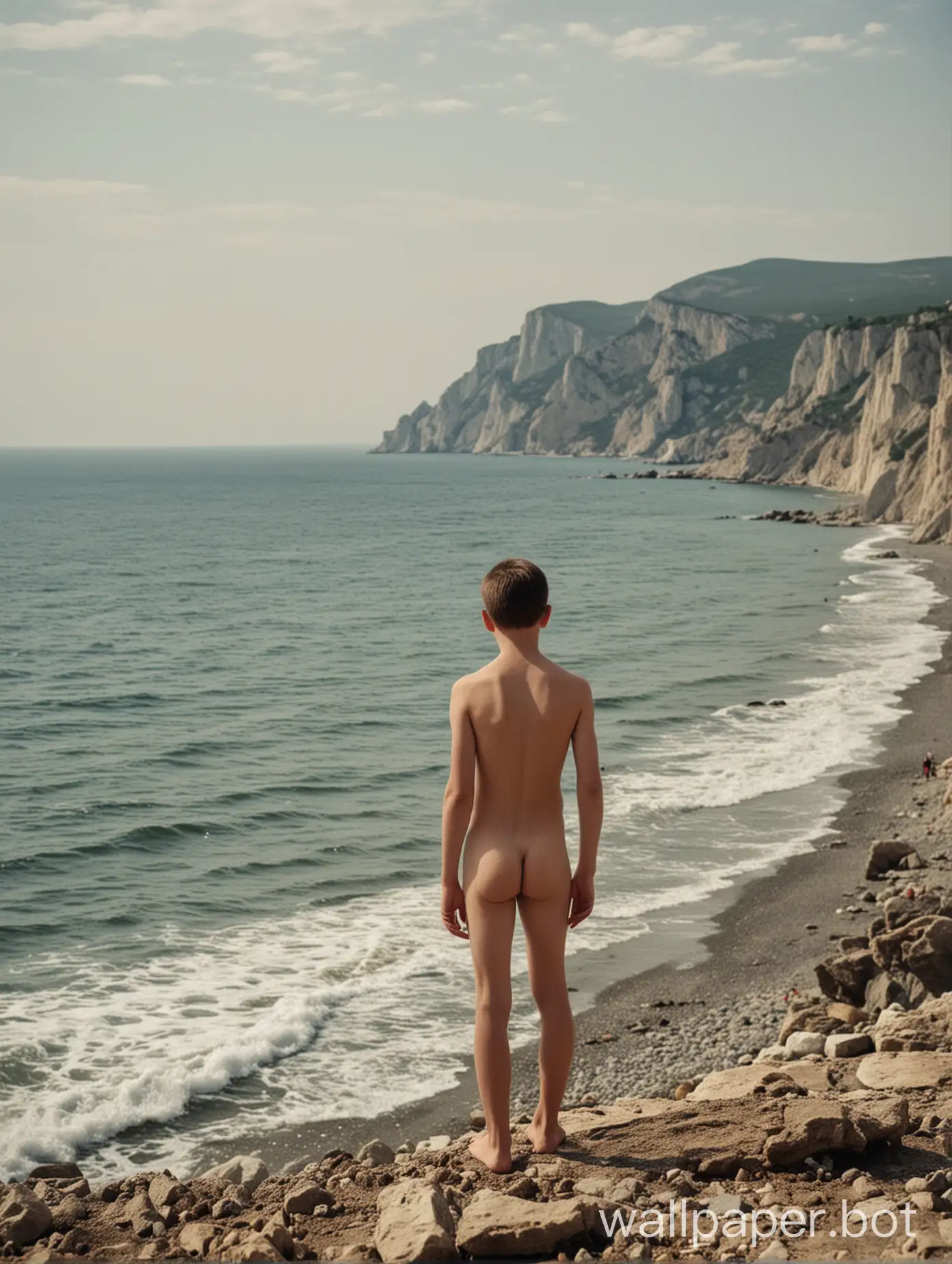 Crimea, view of the sea, naked boy 14 years old, full height, people in the distance