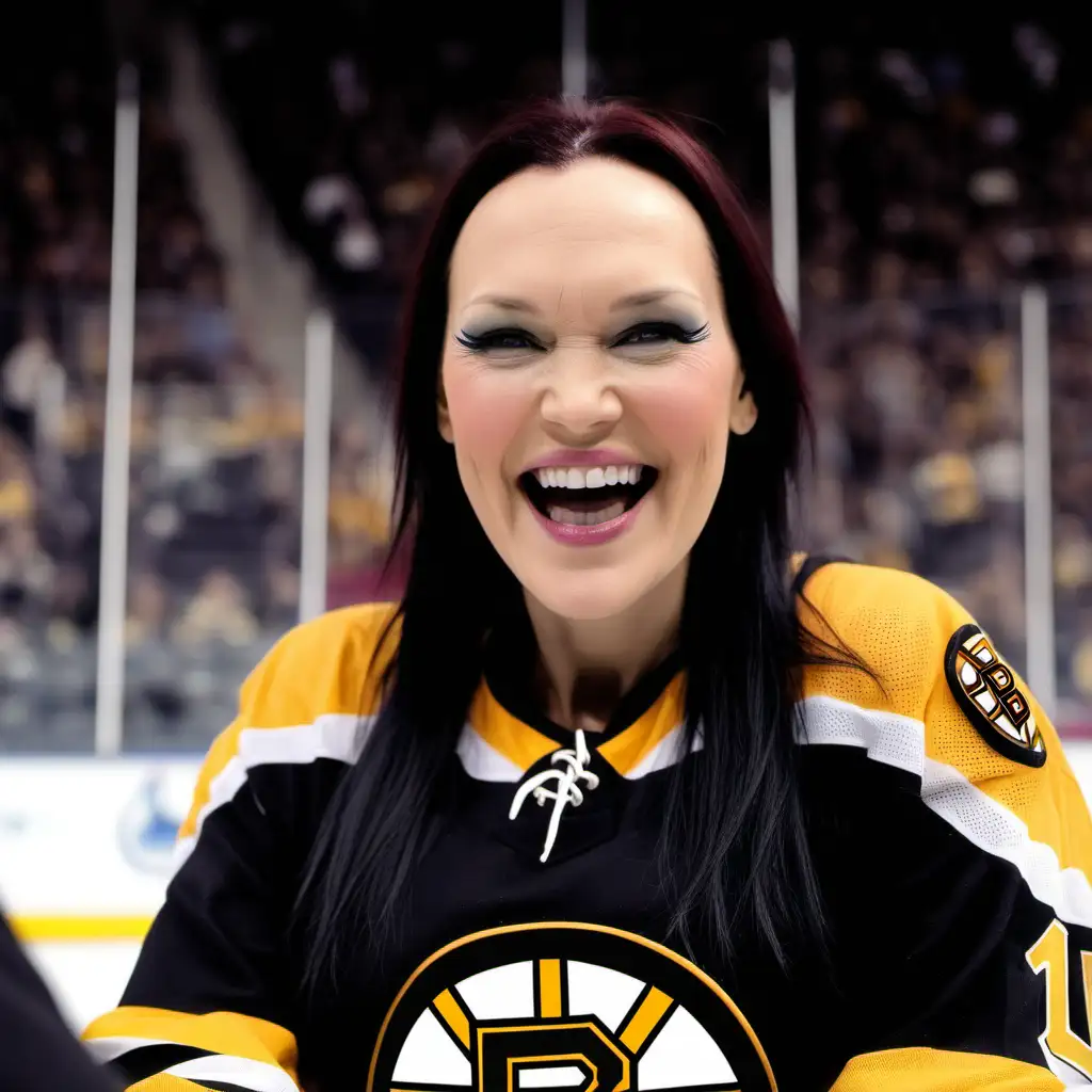 Tarja Turunen wearing a Boston Bruins jersey. She is in the stands of an ice arena celebrating the hockey team's win. She is smiling beautifully